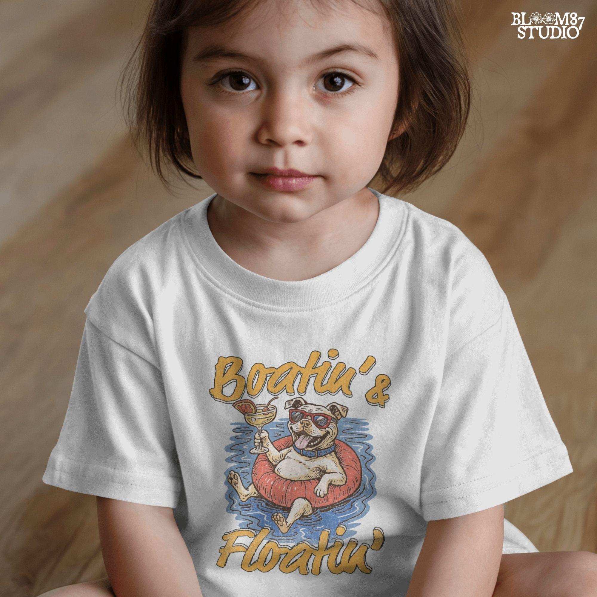 Cartoon bulldog in red sunglasses floating on a tube, holding a margarita, with “Boatin’ & Floatin’” summer text.