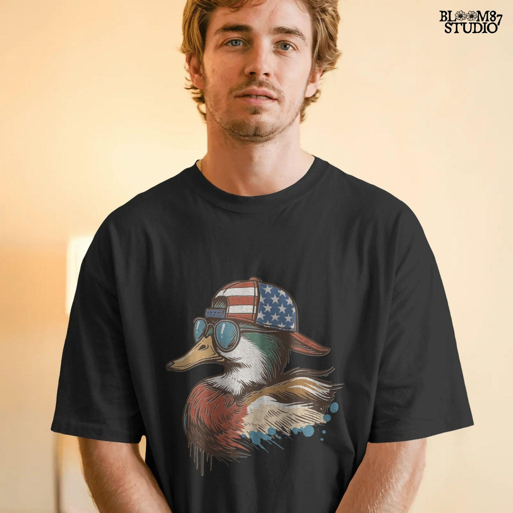 Cartoon mallard duck wearing American flag hat and sunglasses in a humorous patriotic style, with bold colors and splash detail