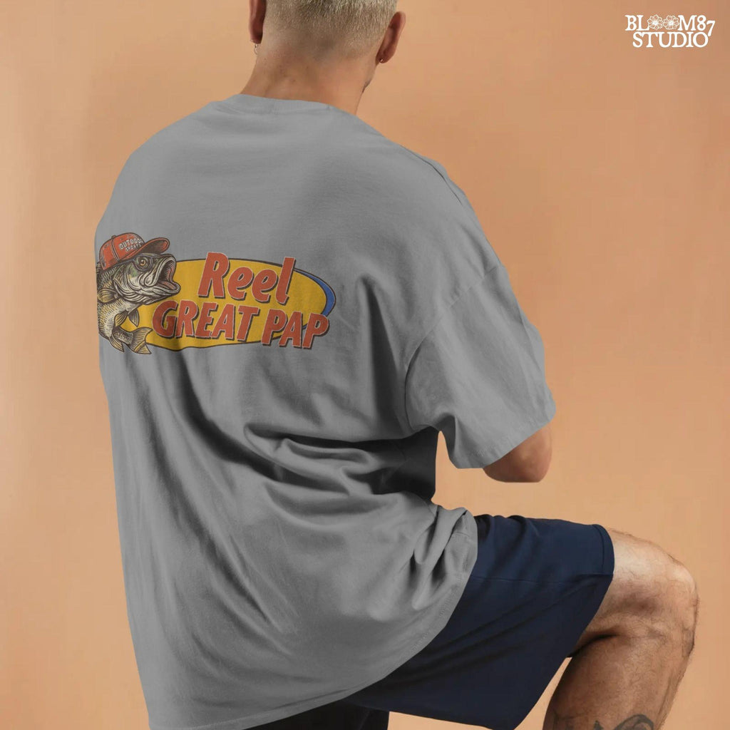 Vintage-style illustration of a largemouth bass in a red hat with retro text “Reel Great Pap” on a yellow and blue background