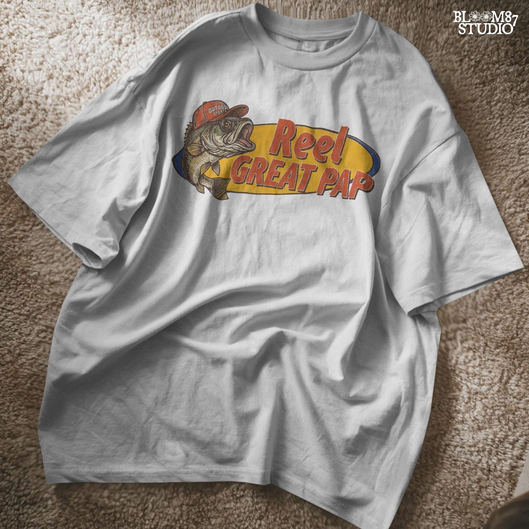 Vintage-style illustration of a largemouth bass in a red hat with retro text “Reel Great Pap” on a yellow and blue background