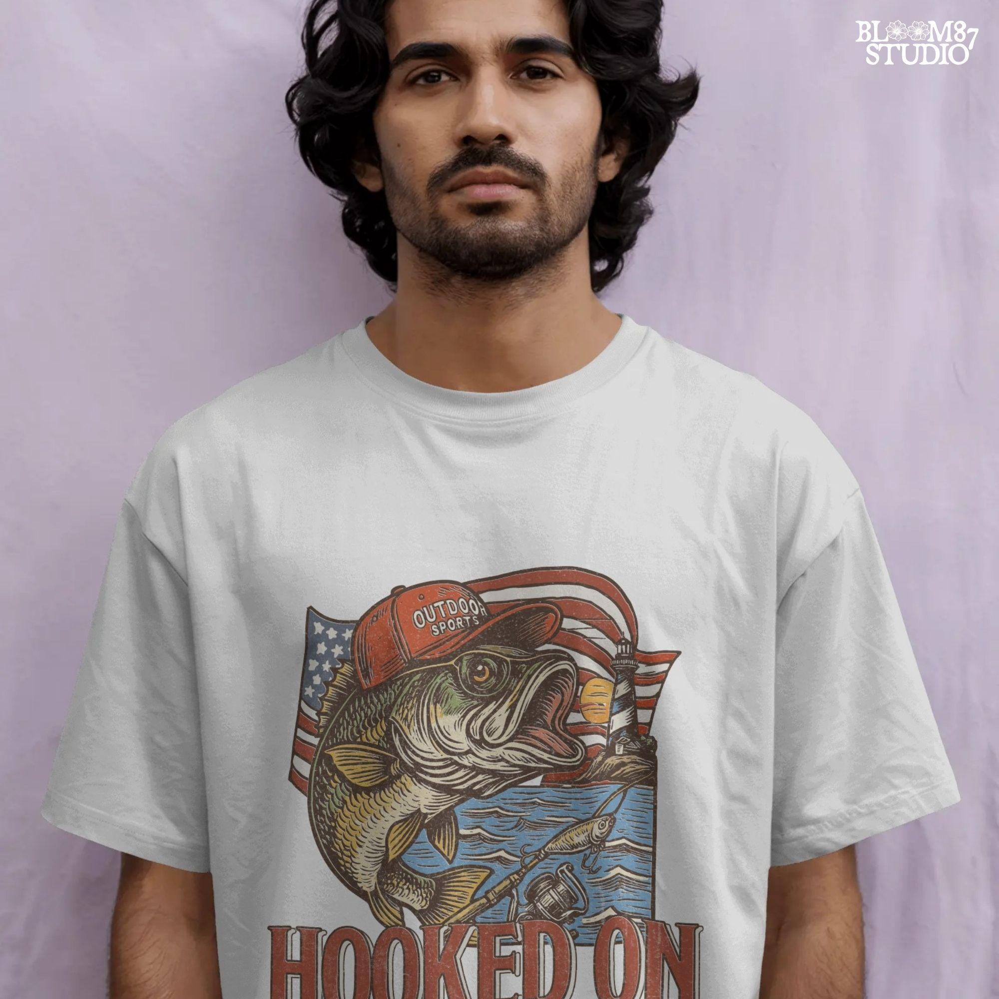 Patriotic bass fish wearing red cap with American flag, lighthouse, and “Hooked on Freedom” text – ideal for 4th of July fishing designs.