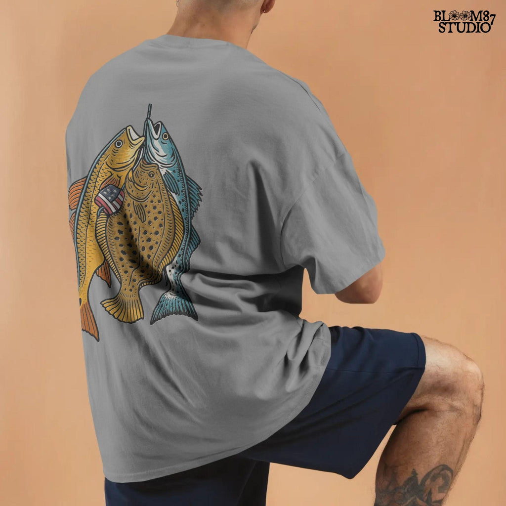 Three saltwater game fish (redfish, flounder, trout) hanging from a line, with a small American flag detail on one fish, in vintage patriotic fishing style