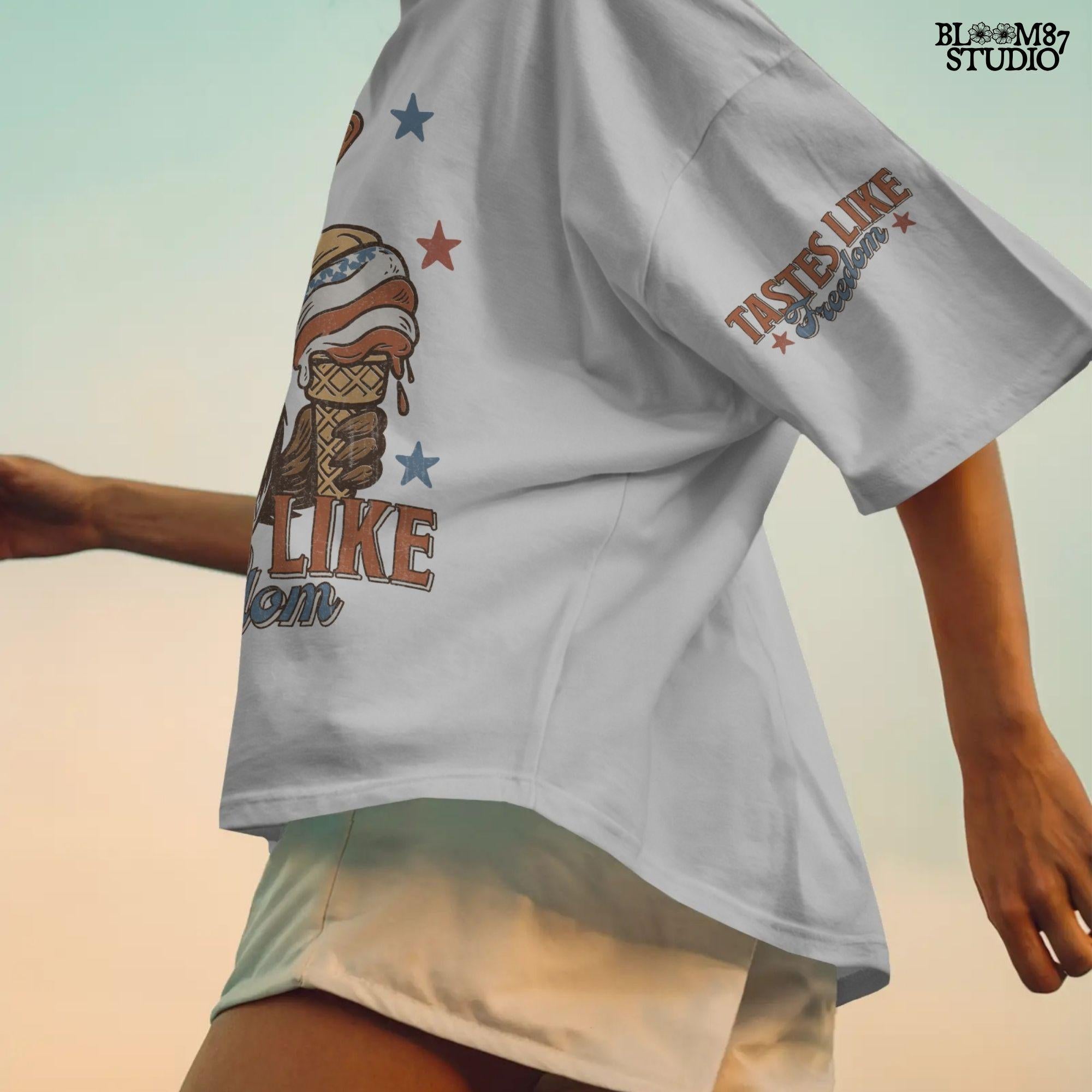 Funny cartoon duck wearing USA hat and star sunglasses, licking patriotic ice cream cone with “Tastes Like Freedom” text and red-white-blue stars