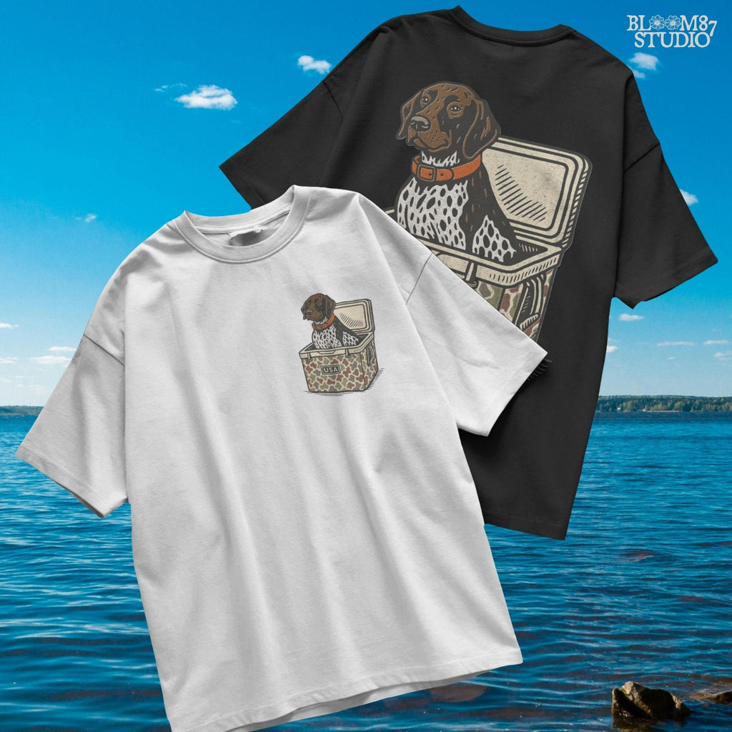 German Shorthaired Pointer dog sitting inside camouflage cooler labeled “USA,” in rustic cartoon patriotic style