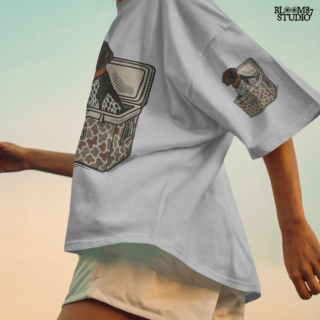 German Shorthaired Pointer dog sitting inside camouflage cooler labeled “USA,” in rustic cartoon patriotic style