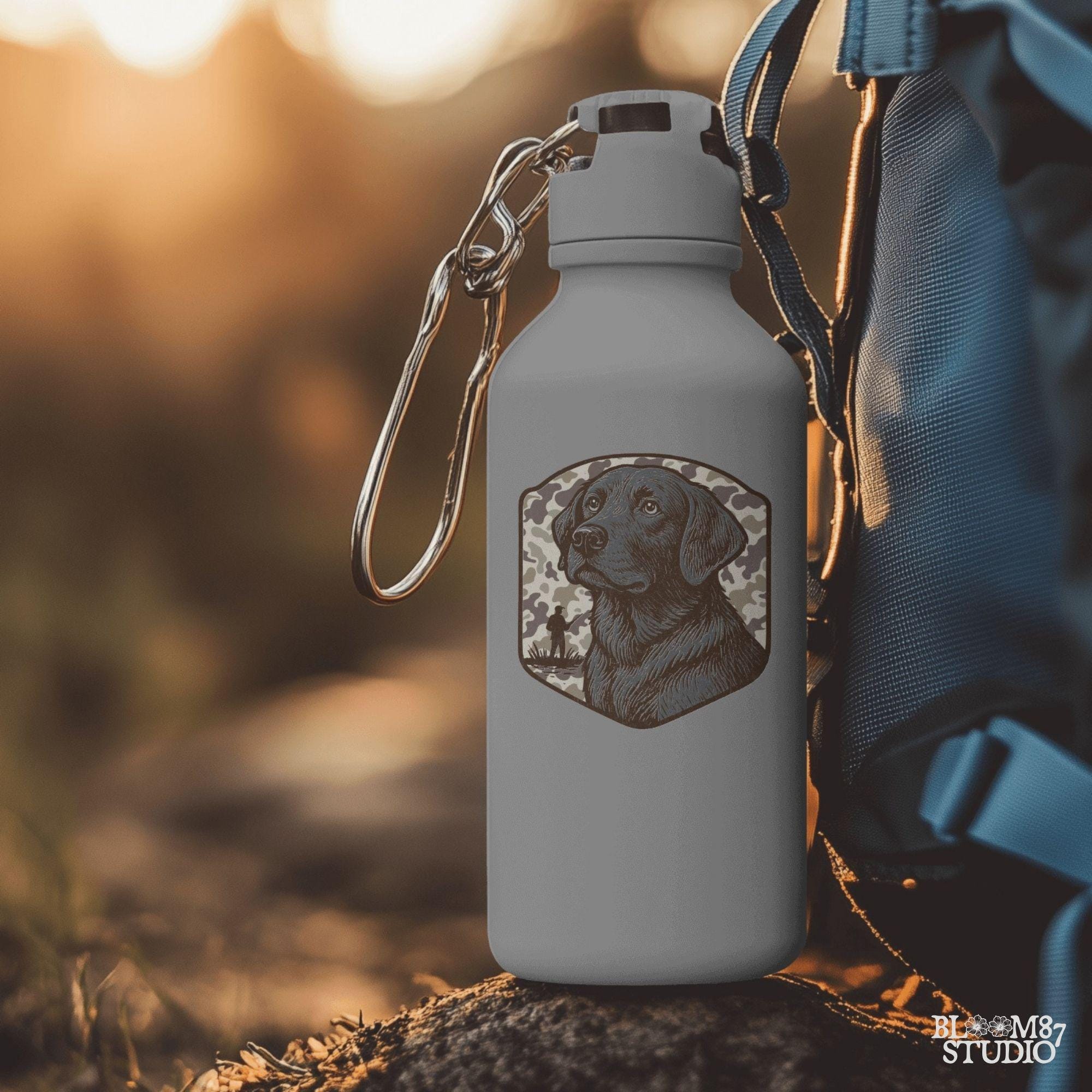 Hand-drawn black Labrador retriever with camo background and duck hunter silhouette – vintage-style sublimation design for outdoor lovers.