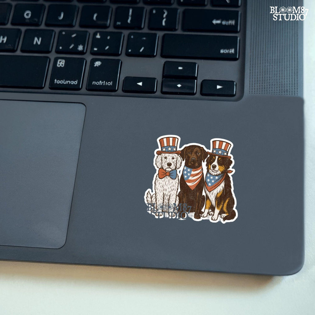 Cartoon-style Goldendoodle, Chocolate Labrador, and Australian Shepherd wearing patriotic USA outfits for 4th of July