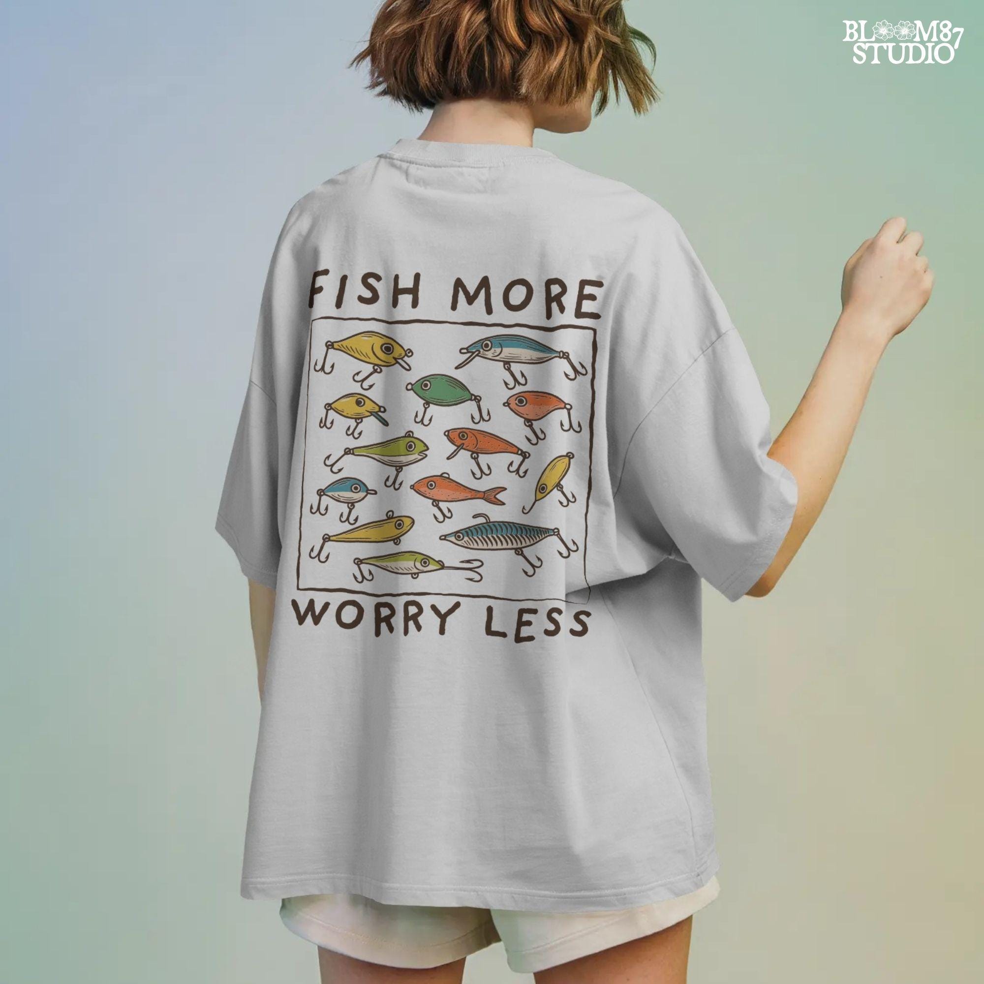 Hand-drawn vintage fishing lures with “Fish More Worry Less” quote in rustic outdoor style, colorful PNG for sublimation.