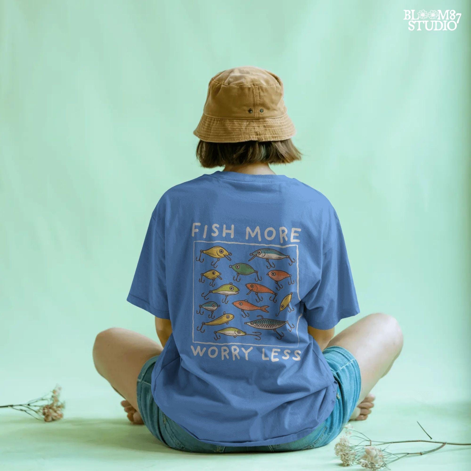 Hand-drawn vintage fishing lures with “Fish More Worry Less” quote in rustic outdoor style, colorful PNG for sublimation.