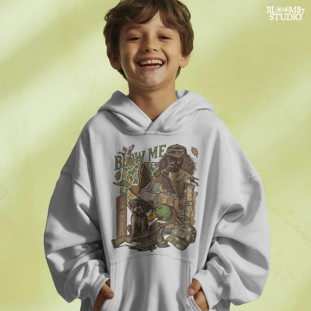 Retro collage of duck hunting elements including mallards, camo, duck dog, country boy rifle, and “Blow Me” southern humor quote.