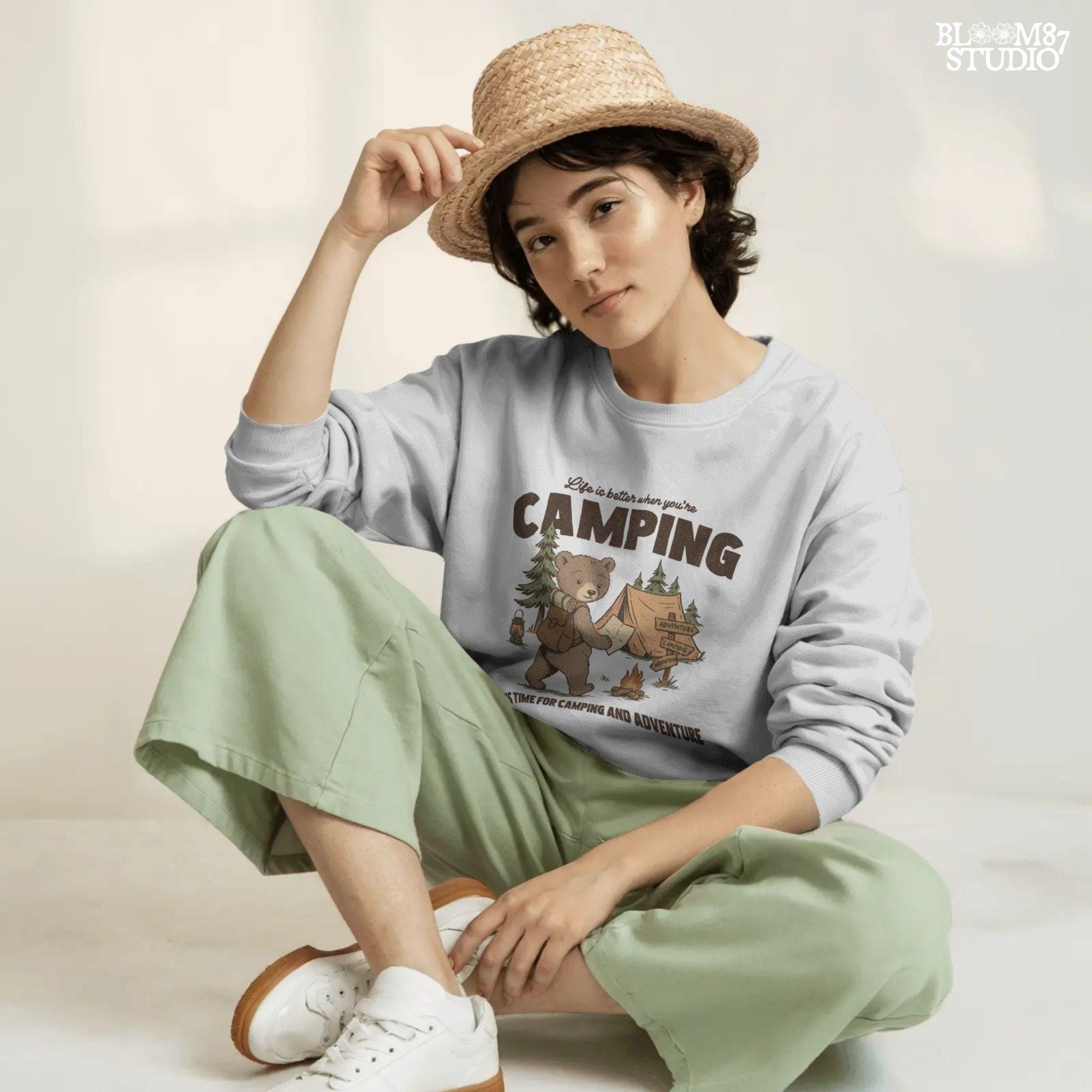 Cute bear with a backpack and camping map standing by a tent, campfire, and wooden adventure signs in a forest scene.