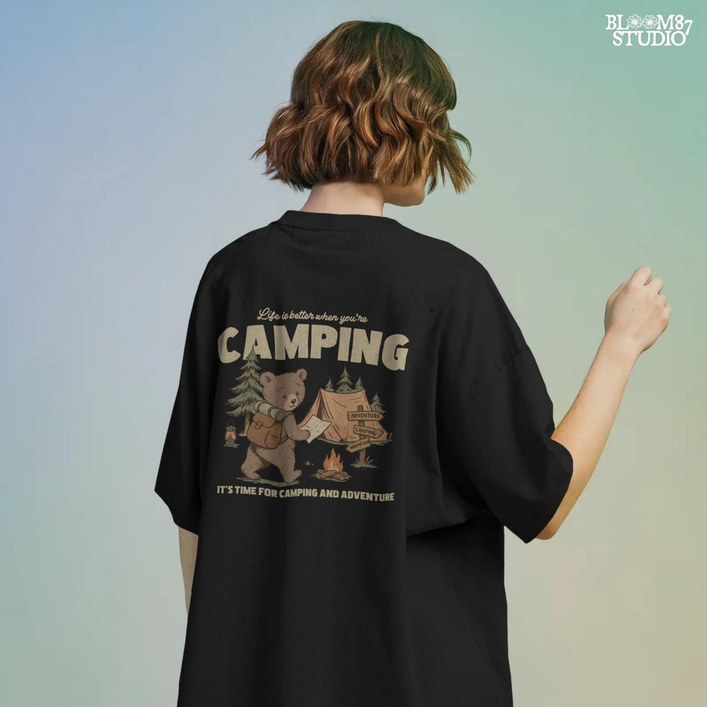 Cute bear with a backpack and camping map standing by a tent, campfire, and wooden adventure signs in a forest scene.