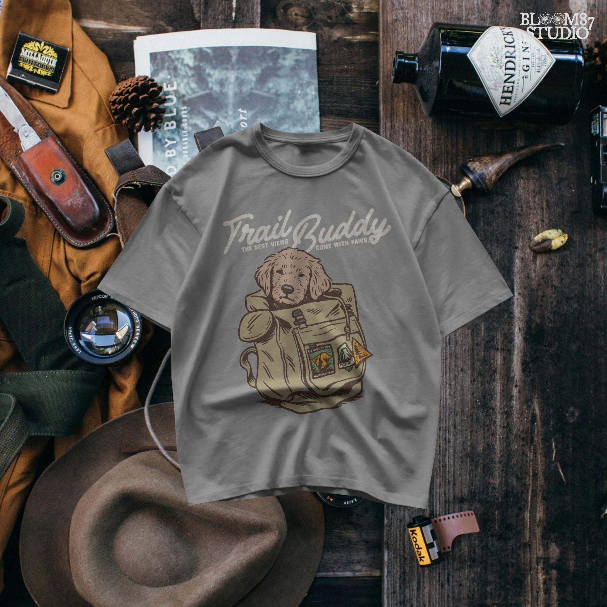 Hand-drawn illustration of a dog in a vintage hiking backpack with National Park patches and the phrase “The Best Views Come with Paws,” designed for sublimation.