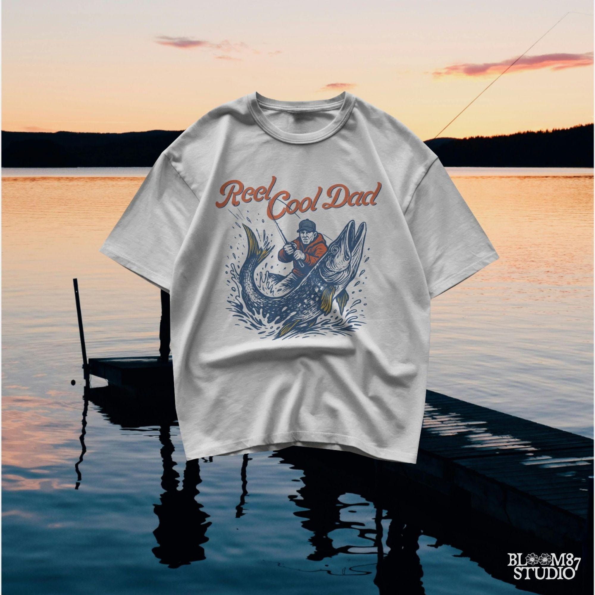 Illustration of a father reeling in a giant fish with bold text “Reel Cool Dad,” perfect for Father’s Day or fishing-themed gifts.