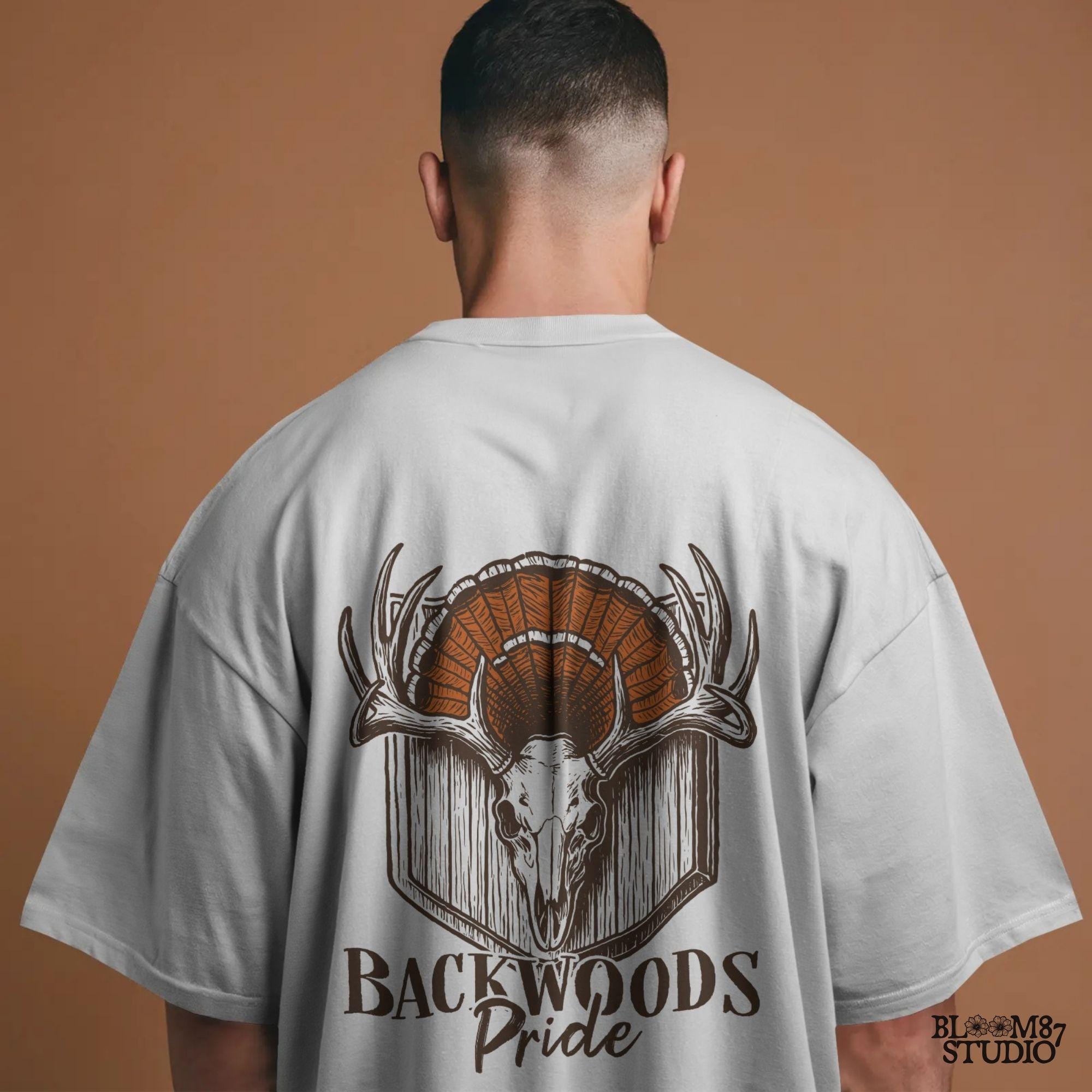 Rustic design of a deer skull with antlers and a turkey fan backdrop above the words “Backwoods Pride,” perfect for country and hunting themes.