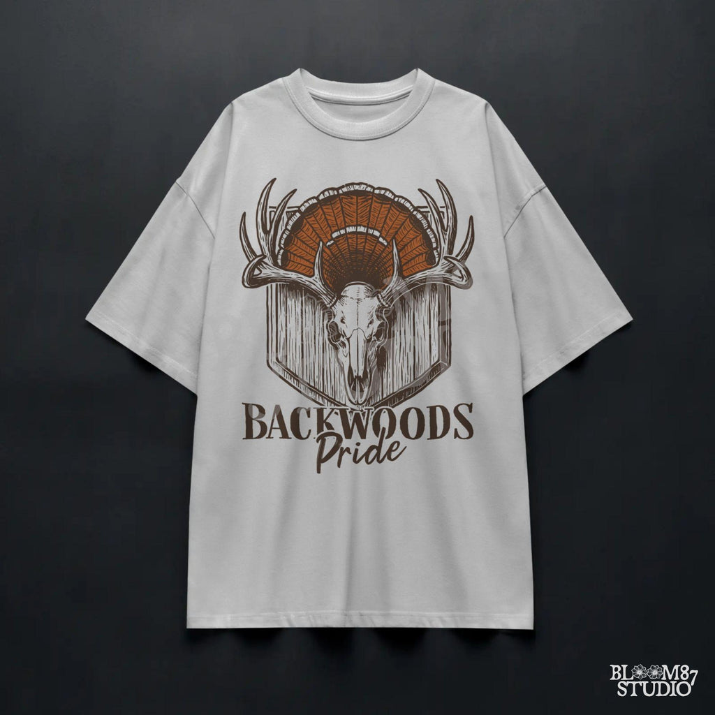 Rustic design of a deer skull with antlers and a turkey fan backdrop above the words “Backwoods Pride,” perfect for country and hunting themes.