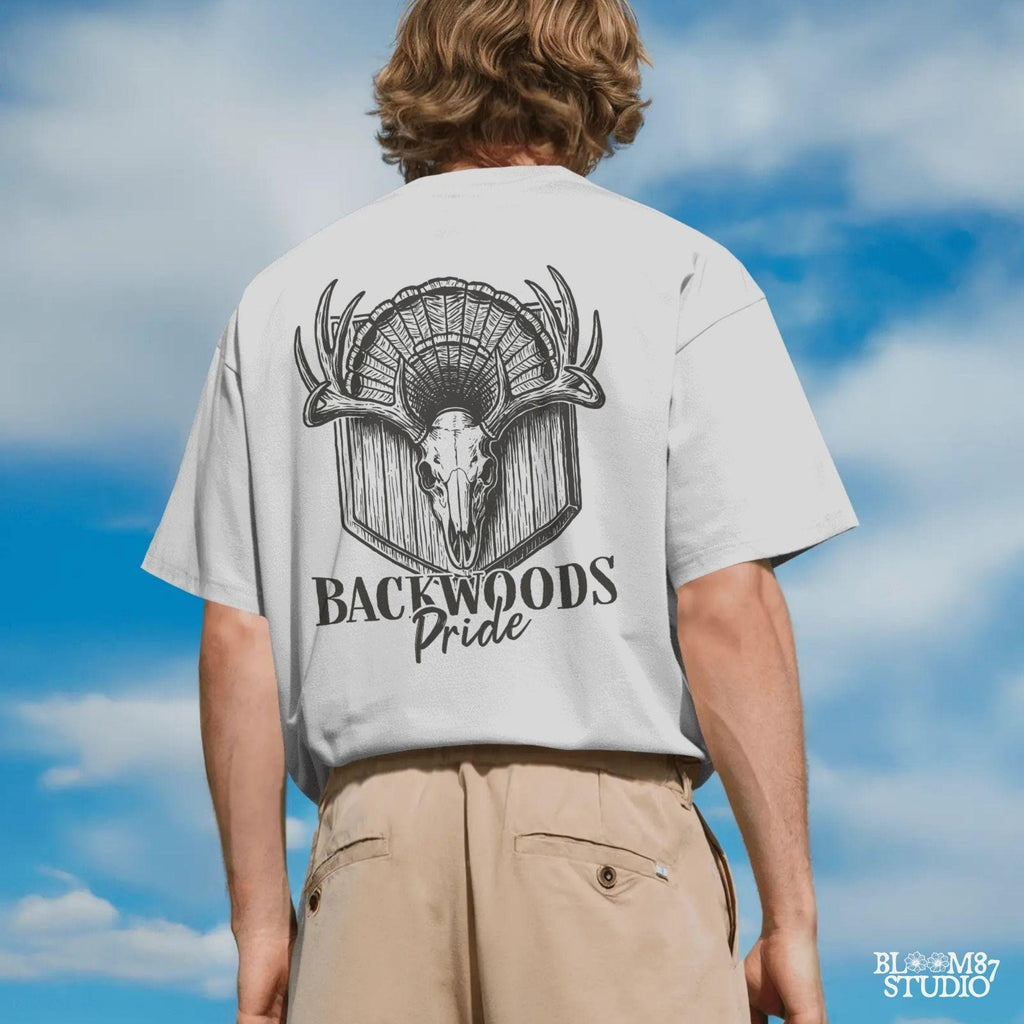 Rustic design of a deer skull with antlers and a turkey fan backdrop above the words “Backwoods Pride,” perfect for country and hunting themes.