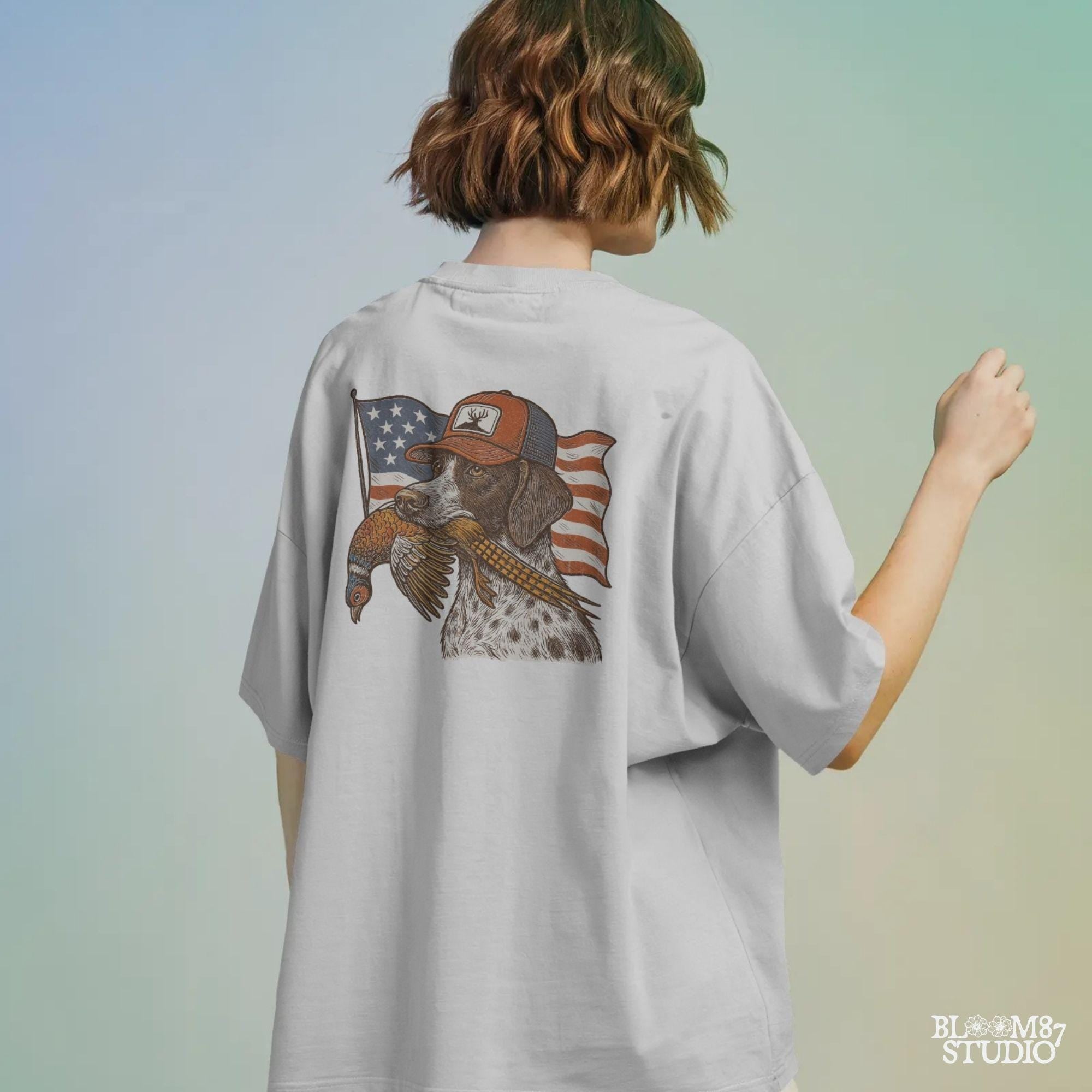 Hunting dog wearing a cap and holding a pheasant in its mouth, with a waving American flag in the background.