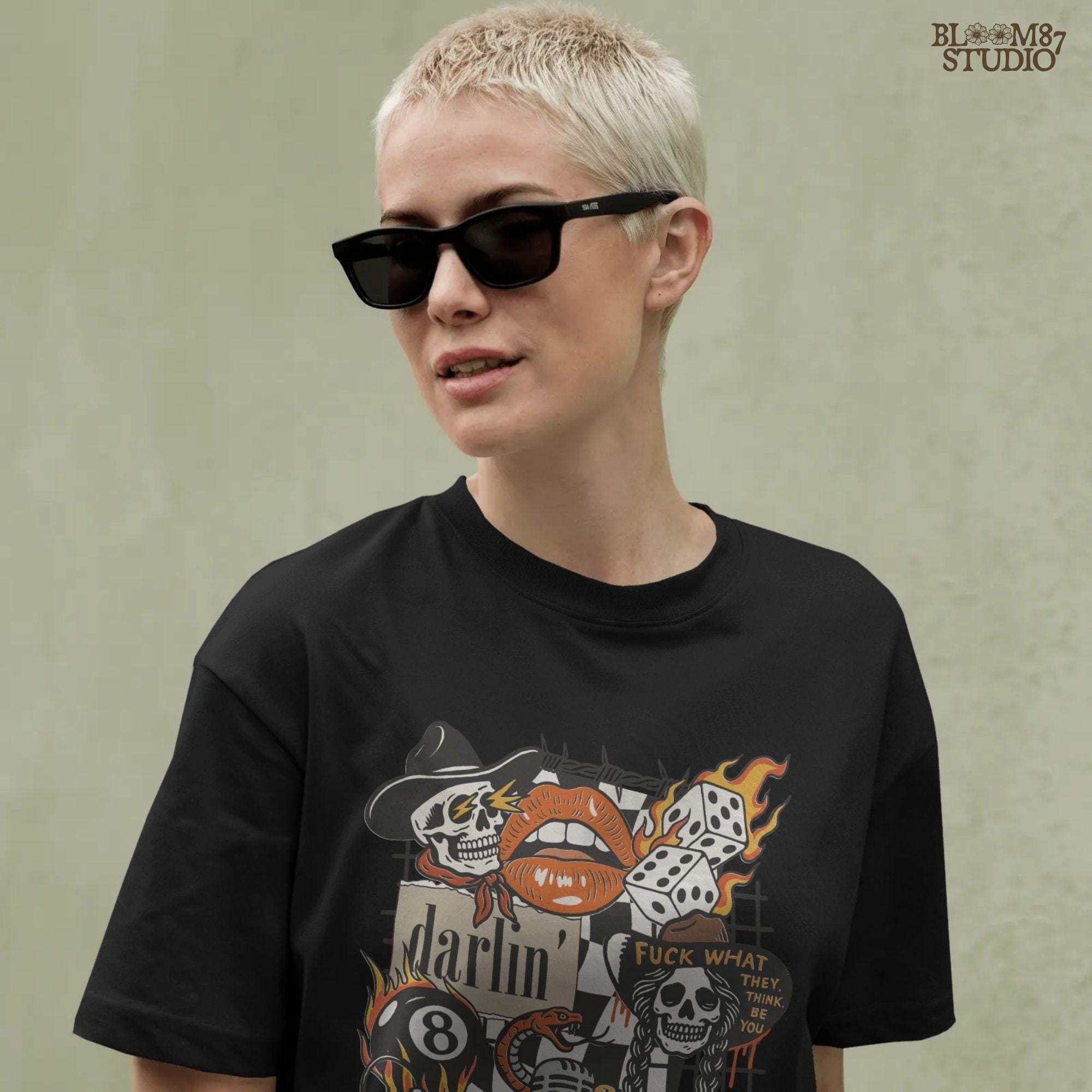 Western punk collage design featuring skulls, lips, leopard with heart glasses, snake and microphone, dice, barbed wire, and 777 tag.