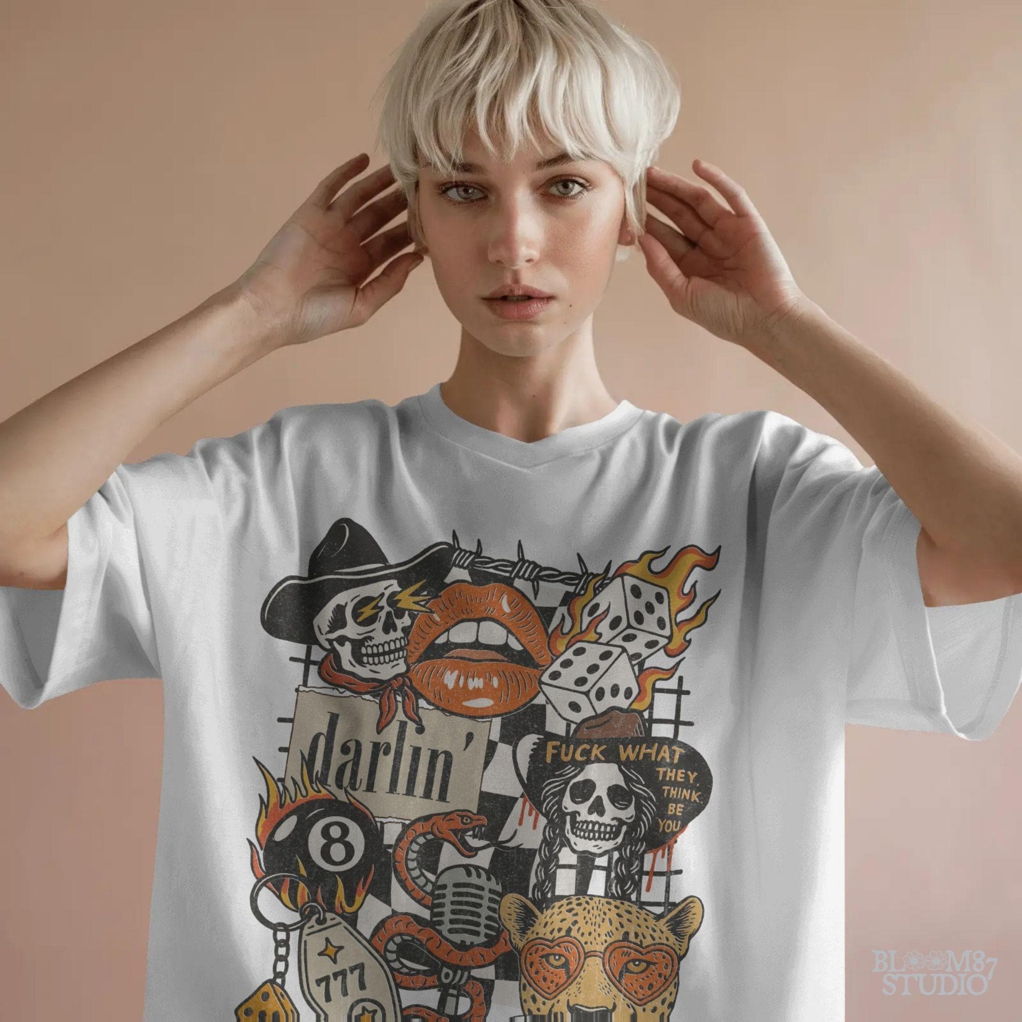 Western punk collage design featuring skulls, lips, leopard with heart glasses, snake and microphone, dice, barbed wire, and 777 tag.