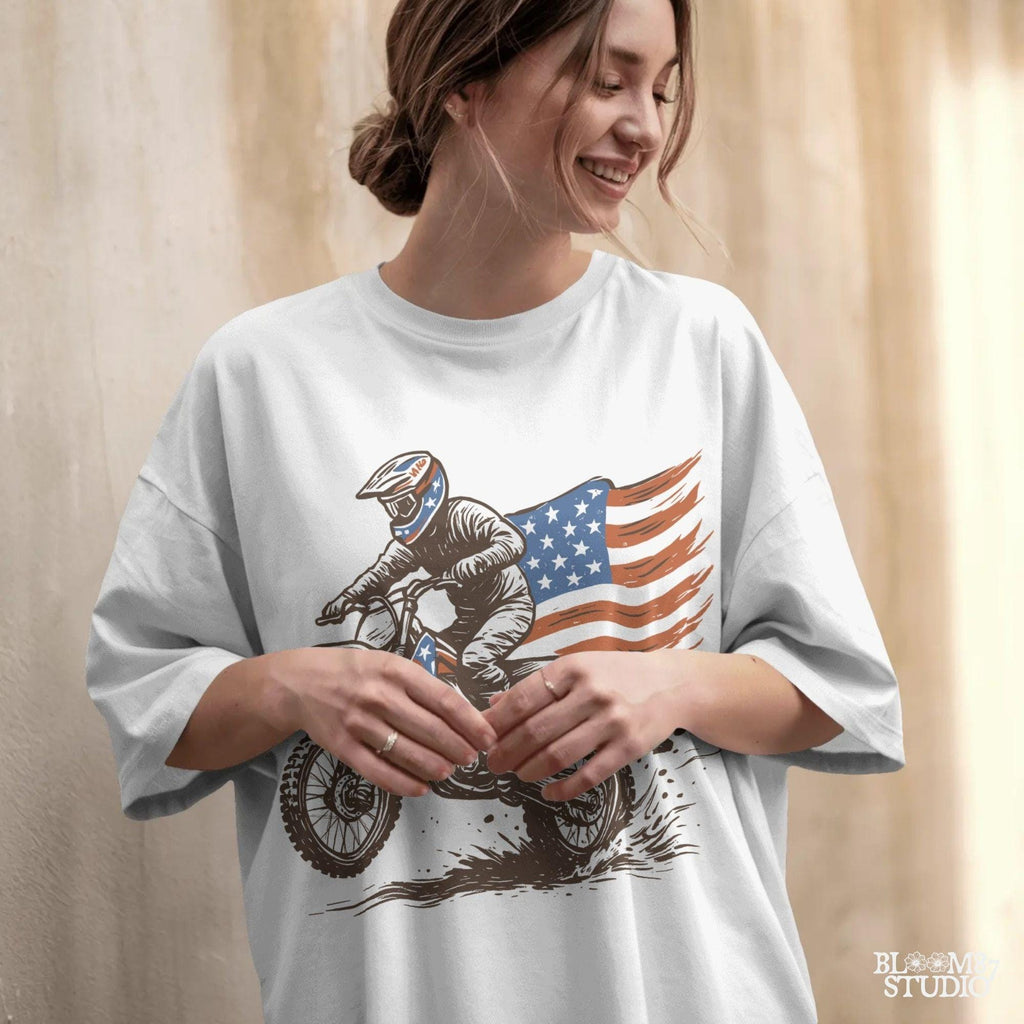 Patriotic motocross rider doing a dirt jump on a dirt bike with the American flag flowing behind, in a bold western vintage style illustration.