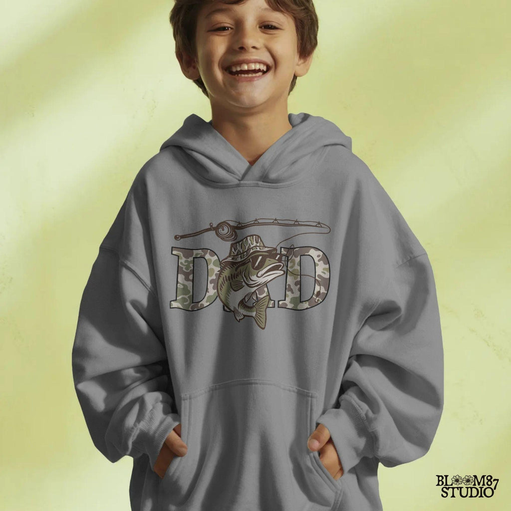 A funny camo bass fish wearing sunglasses and a camo bucket hat, with large camouflage DAD lettering and a fishing pole above.