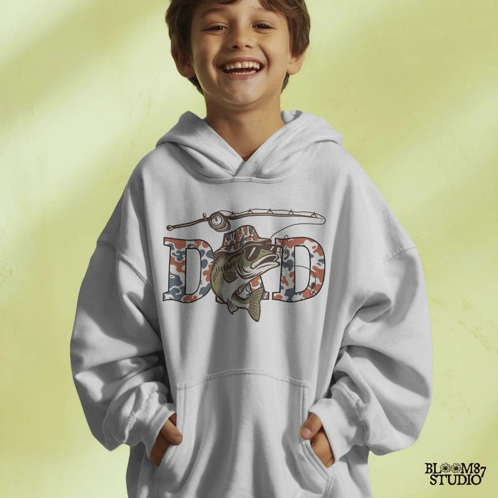 A cool bass fish wearing sunglasses and a bucket hat over red white and blue camo letters spelling DAD, with a fishing rod above.