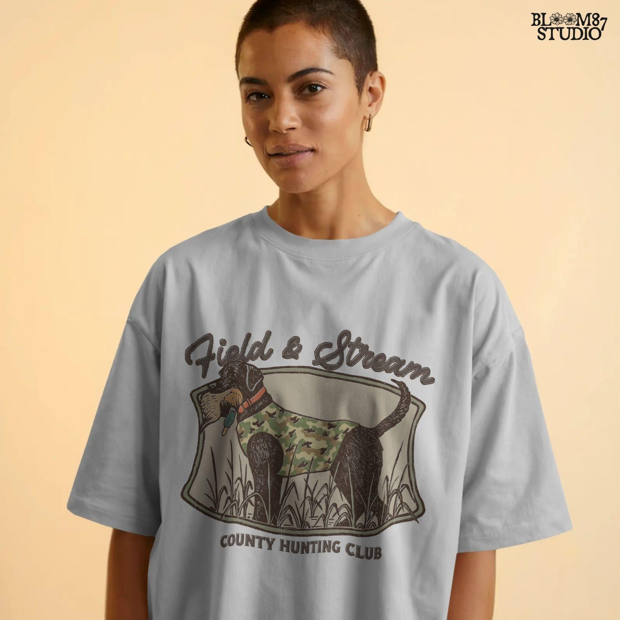 Vintage-style hunting club patch design featuring a black labrador in camo with a duck in its mouth, and the text “Field & Stream – County Hunting Club,” ideal for sublimation.