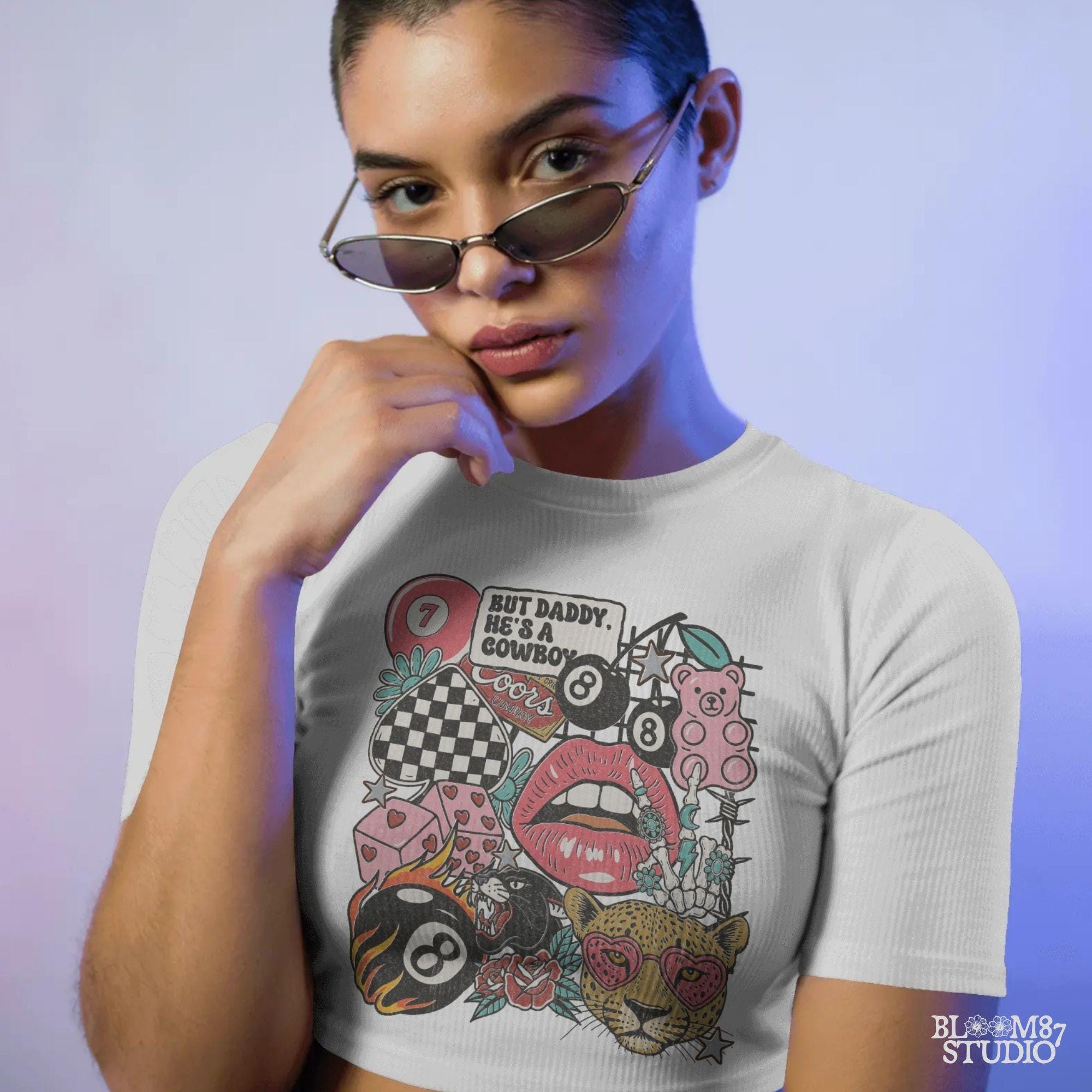 Western howdy collage PNG with “But Daddy He’s a Cowboy” quote, leopard with heart sunglasses, lips, 8 balls, dice, pink bear, and checkerboard.