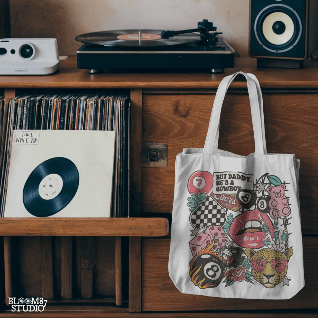Western howdy collage PNG with “But Daddy He’s a Cowboy” quote, leopard with heart sunglasses, lips, 8 balls, dice, pink bear, and checkerboard.