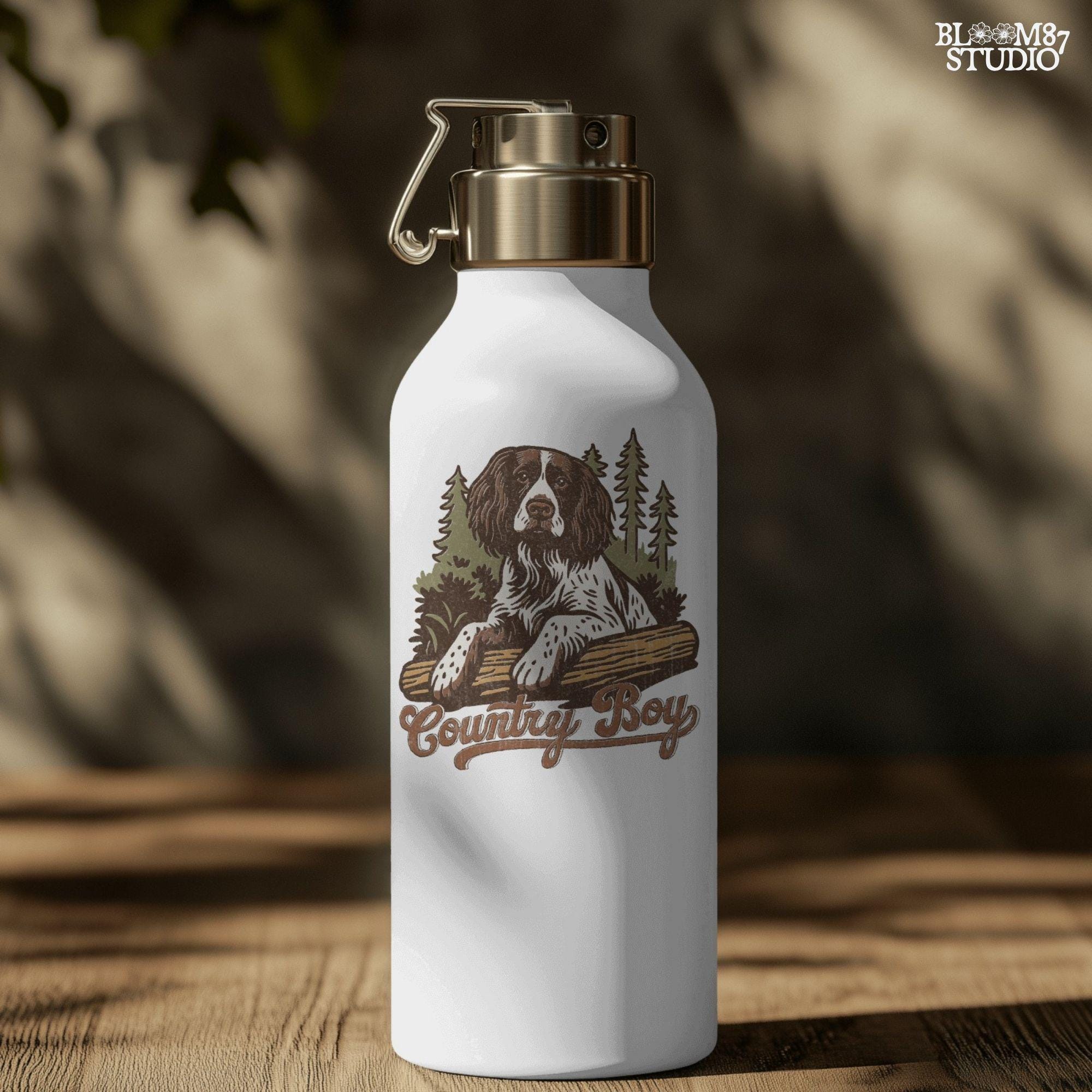 Illustration of a Springer Spaniel dog laying on a log in the woods with the words “Country Boy,” designed for rustic-themed sublimation and hunting dog lovers.