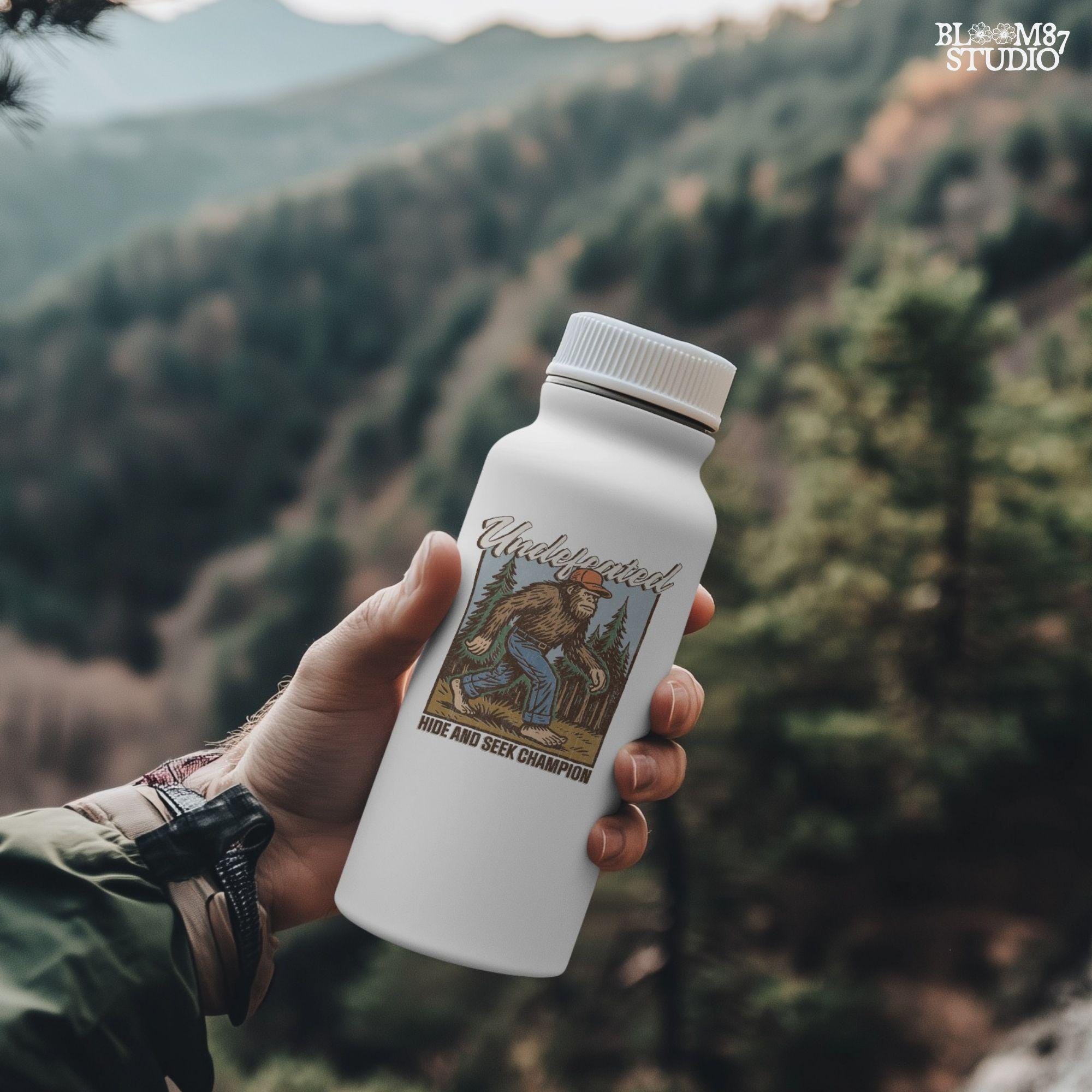 Hand-drawn Bigfoot walking through a pine forest in a red cap and jeans, with text “Undefeated Hide and Seek Champion,” designed for sublimation use.