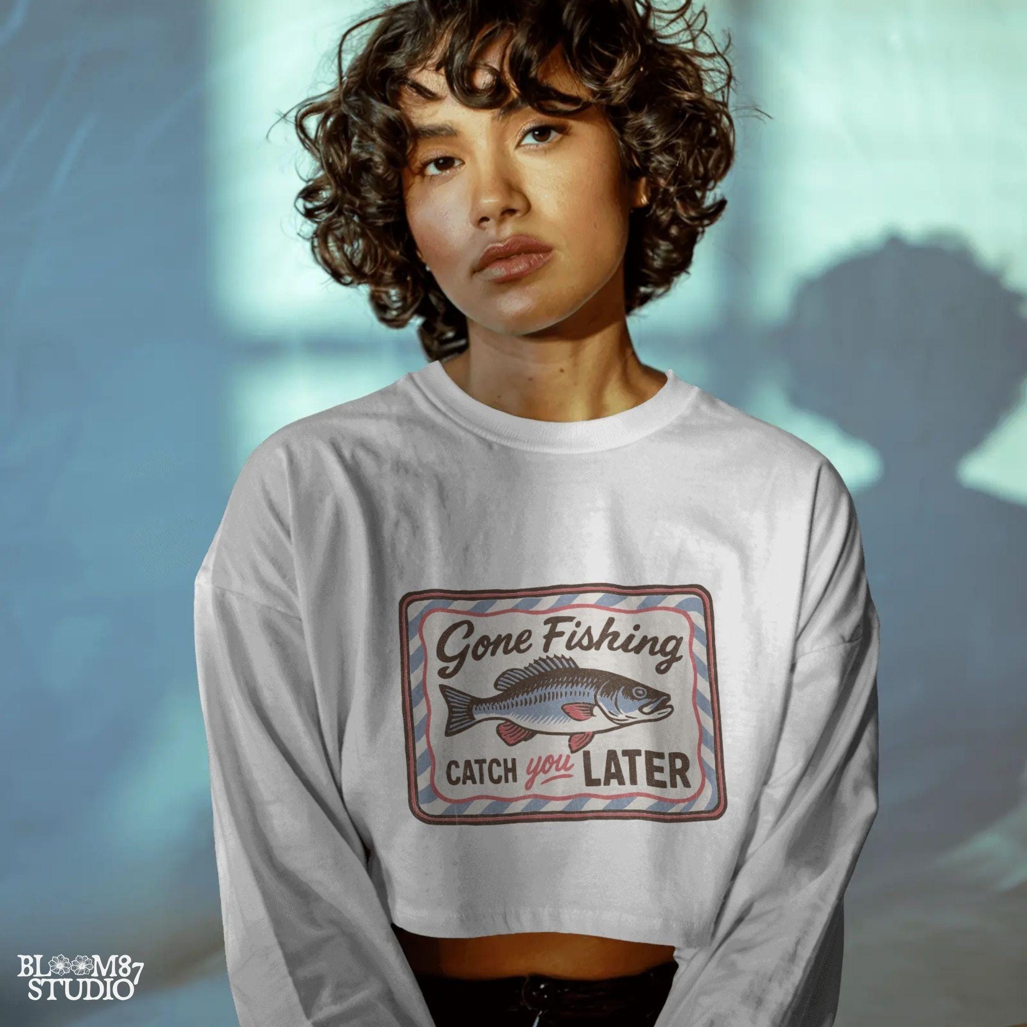 Vintage-style “Gone Fishing Catch You Later” sign with a bold blue and red fish illustration and striped border, ideal for fishing lovers.