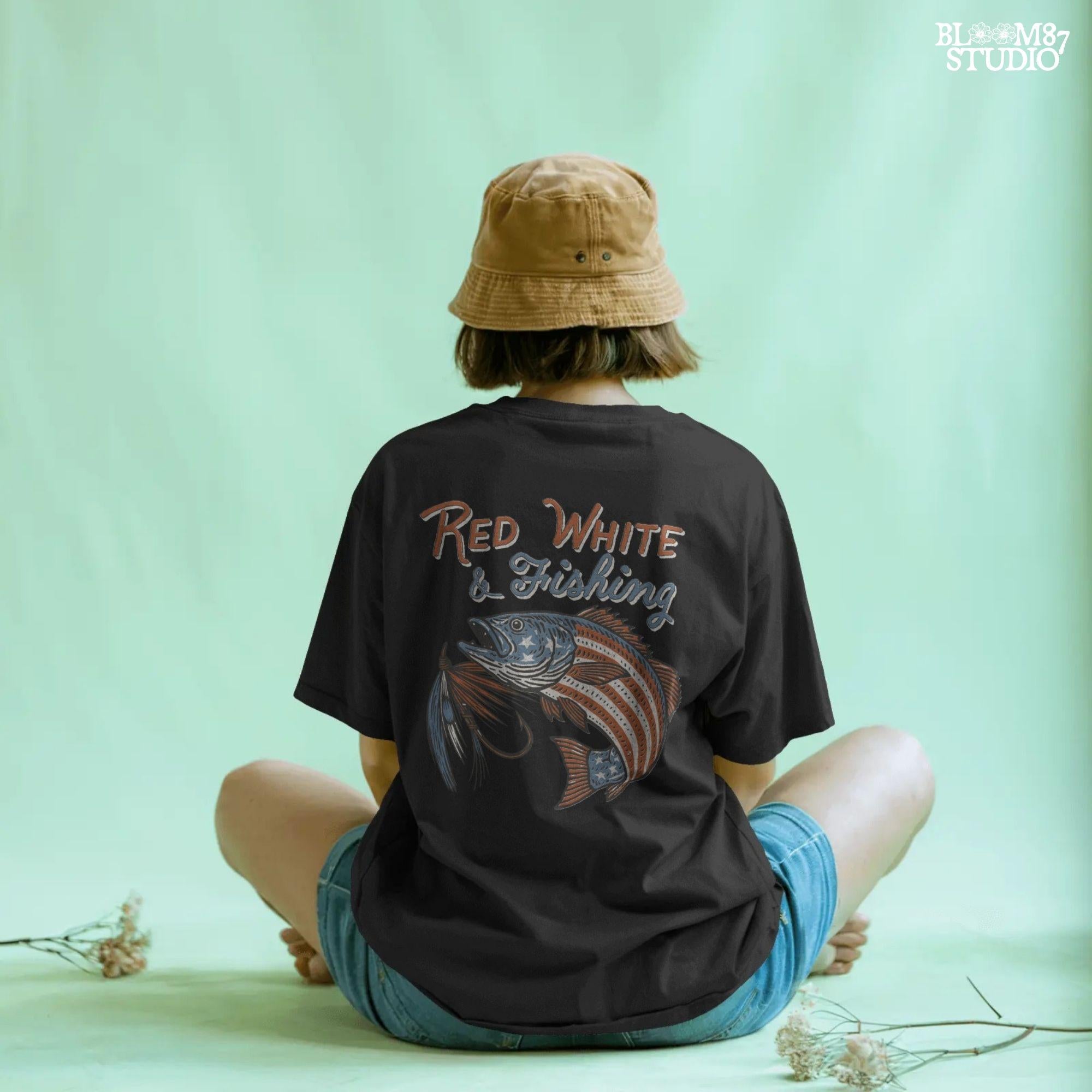 Bass fish decorated with American flag stars and stripes, jumping with a fishing lure and text “Red White & Fishing” in patriotic style.