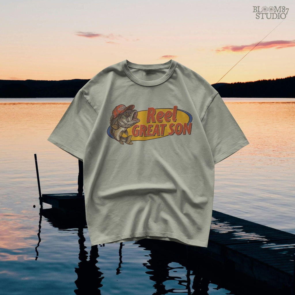 Illustration of a bass fish wearing a red trucker hat with the text “Reel Great Son” in bold vintage lettering, designed for sublimation and fishing-themed gifts for kids.