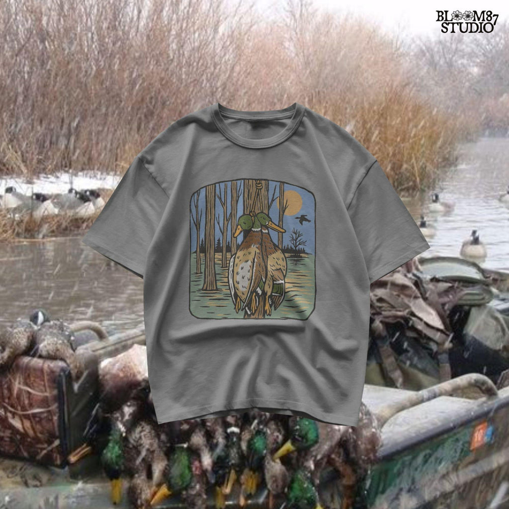 Illustration of two mallard ducks hanging from a tree in a flooded timber swamp at sunset, designed for duck hunting-themed sublimation and lodge decor.