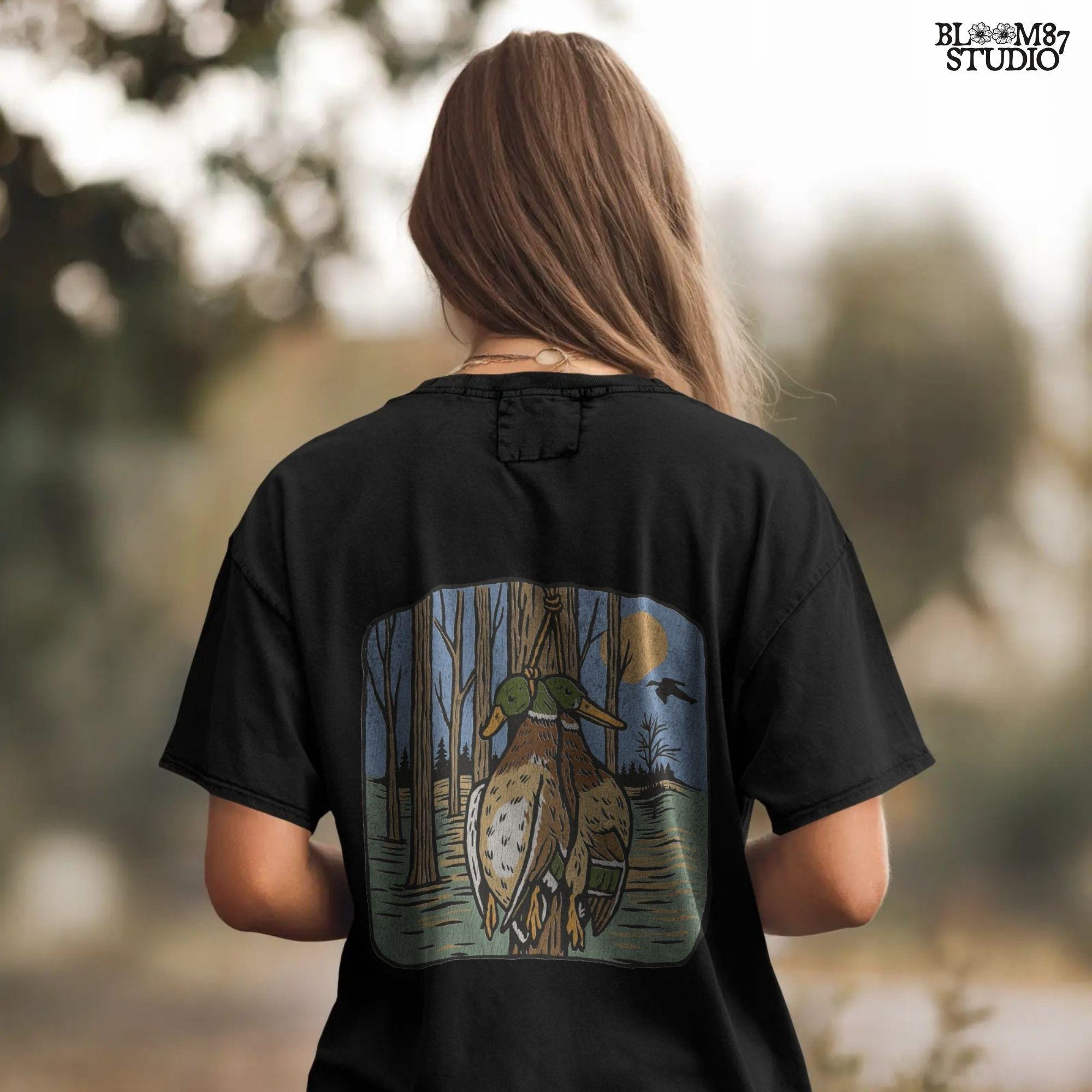 Illustration of two mallard ducks hanging from a tree in a flooded timber swamp at sunset, designed for duck hunting-themed sublimation and lodge decor.