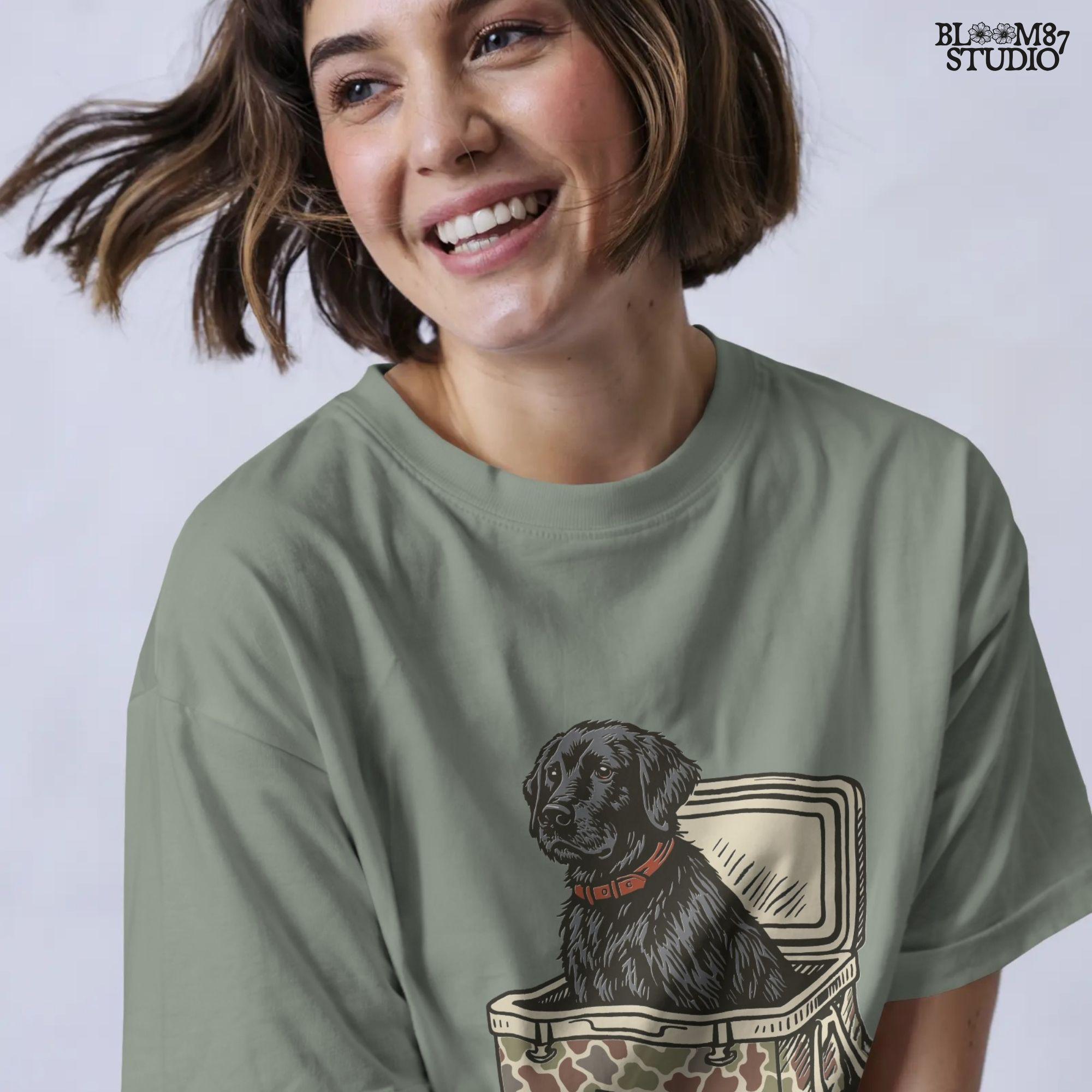 Hand-drawn black Labrador retriever sitting in a camouflage cooler labeled “USA,” designed for sublimation and hunting-themed merchandise.