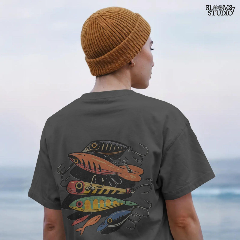 Vintage-style illustration of assorted colorful fishing lures including crankbaits and topwater baits, arranged in a collage, for sublimation and angler designs.