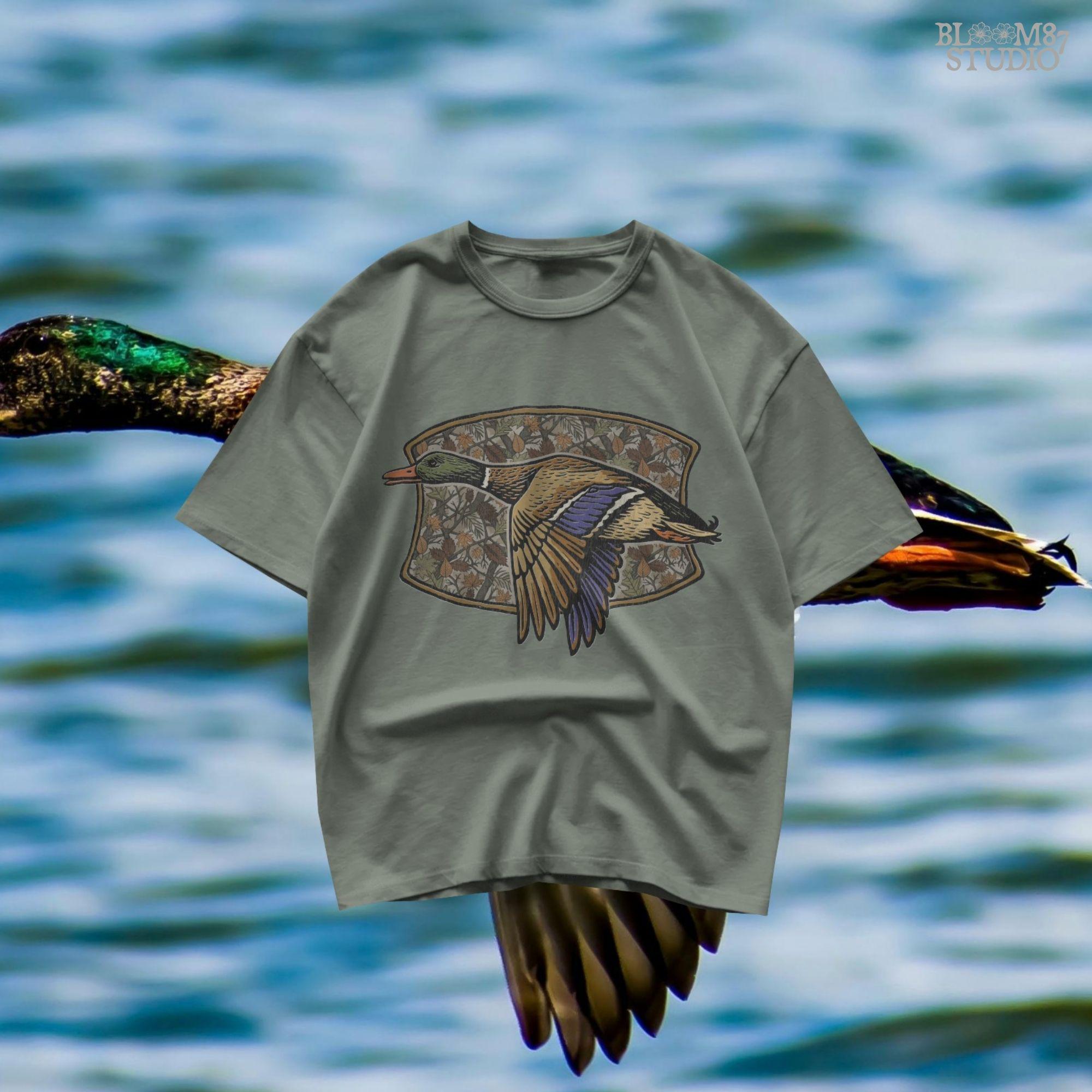 Illustration of a flying mallard duck over a fall camouflage background with oak and maple leaves, designed for hunting-themed sublimation and outdoor shirts.
