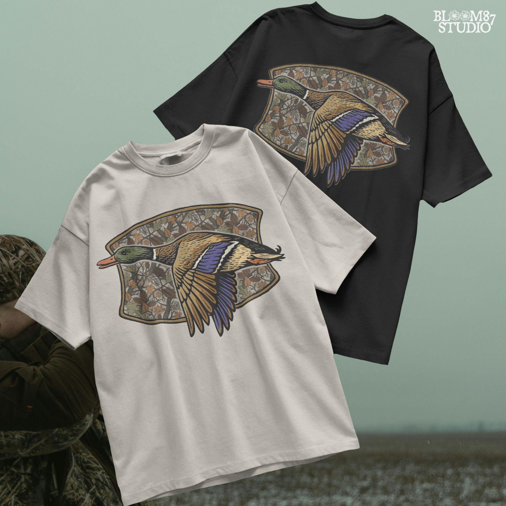 Illustration of a flying mallard duck over a fall camouflage background with oak and maple leaves, designed for hunting-themed sublimation and outdoor shirts.
