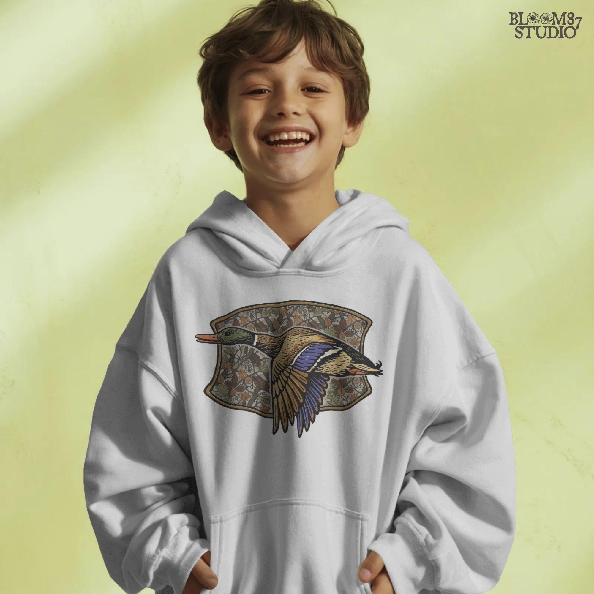 Illustration of a flying mallard duck over a fall camouflage background with oak and maple leaves, designed for hunting-themed sublimation and outdoor shirts.