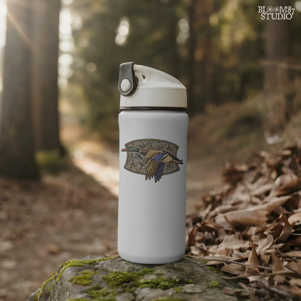 Illustration of a flying mallard duck over a fall camouflage background with oak and maple leaves, designed for hunting-themed sublimation and outdoor shirts.