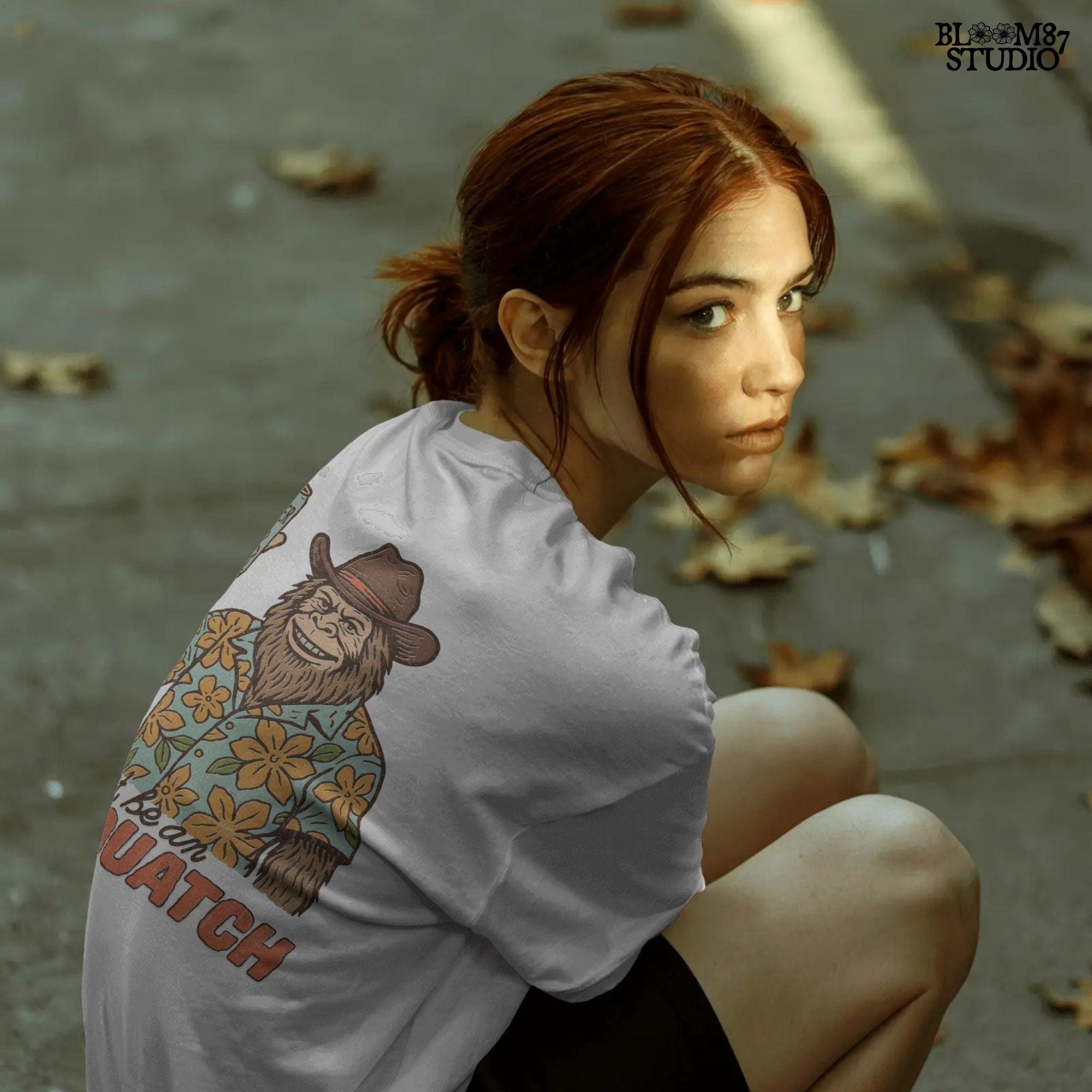 Retro cartoon Sasquatch in floral shirt holding a beer can with text “Don’t Be an Assquatch,” perfect for funny camping or summer designs