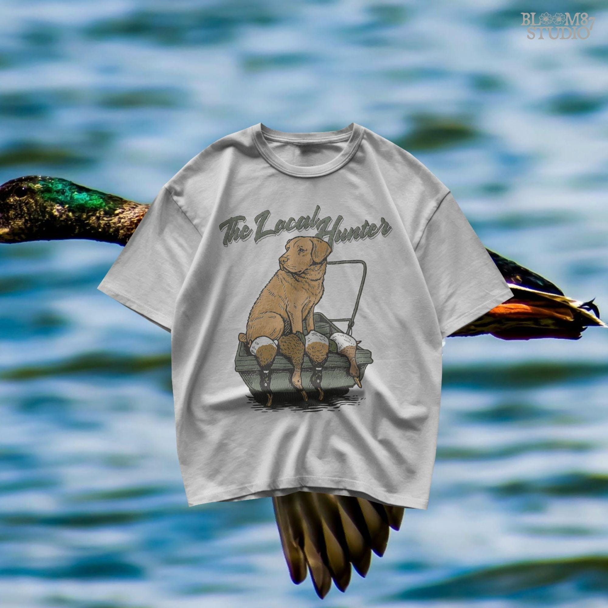 Vintage-style Labrador Retriever sitting in a duck boat with four mallards, text reads “The Local Hunter”, PNG for duck hunting apparel and sublimation.