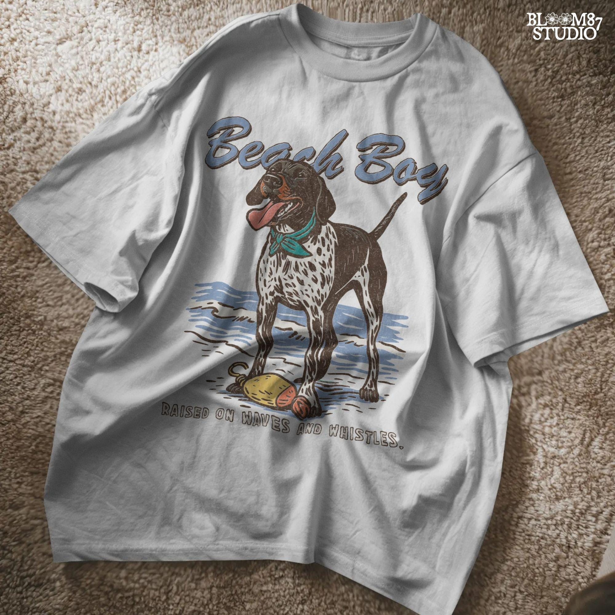 Vintage-style German Shorthaired Pointer standing on the beach with a buoy toy, text reads “Beach Boy – Raised on Waves and Whistles” – summer dog PNG.