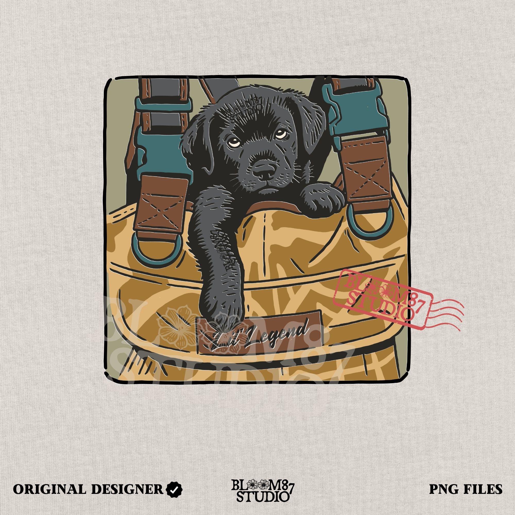 Illustration of a black Labrador puppy resting in a camouflage hunting bag with a “Lil’ Legend” tag – ideal for outdoor-themed sublimation projects.