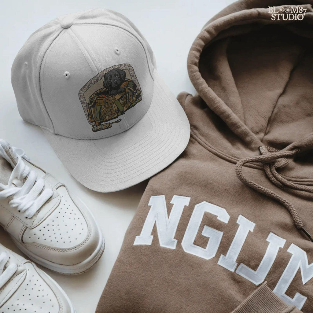 Black Labrador puppy in a camo hunting bag, framed in camouflage pattern, ideal for waterfowl and duck hunting sublimation art.