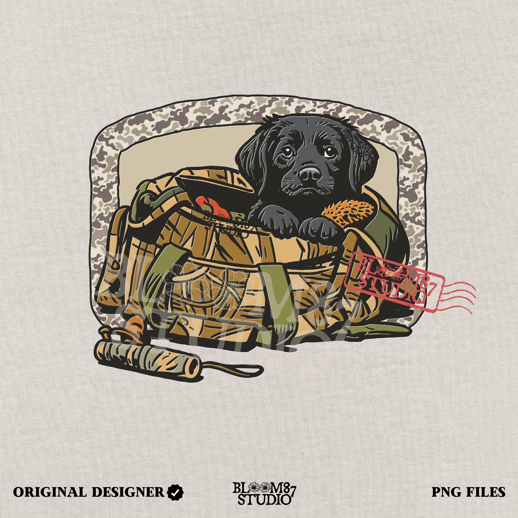 Black Labrador puppy in a camo hunting bag, framed in camouflage pattern, ideal for waterfowl and duck hunting sublimation art.