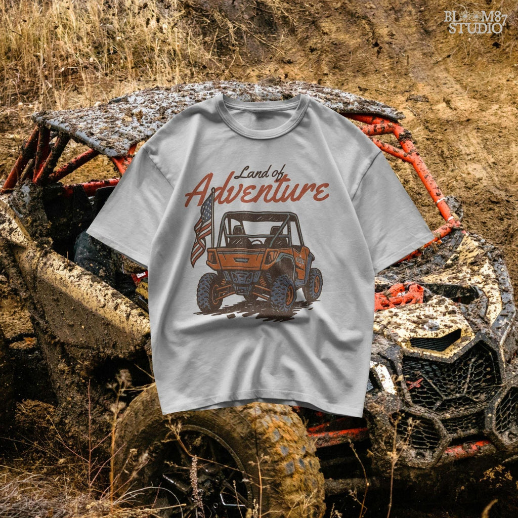Off-road UTV with American flag driving on a dirt trail, text reads “Land of Adventure” – patriotic outdoor sublimation PNG design.